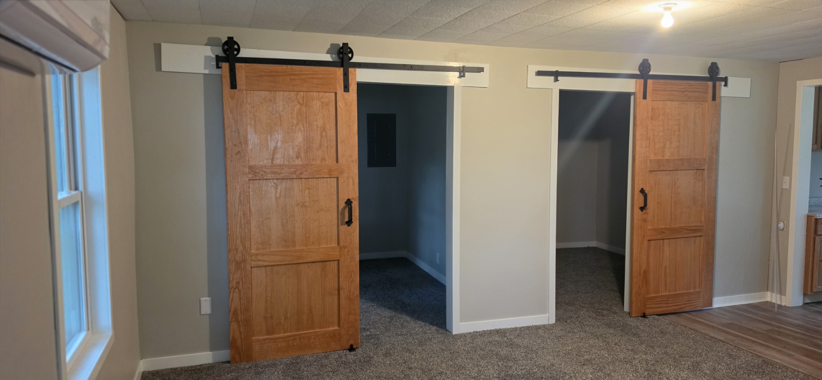 After — double oak sliding barn doors with matte black hardware