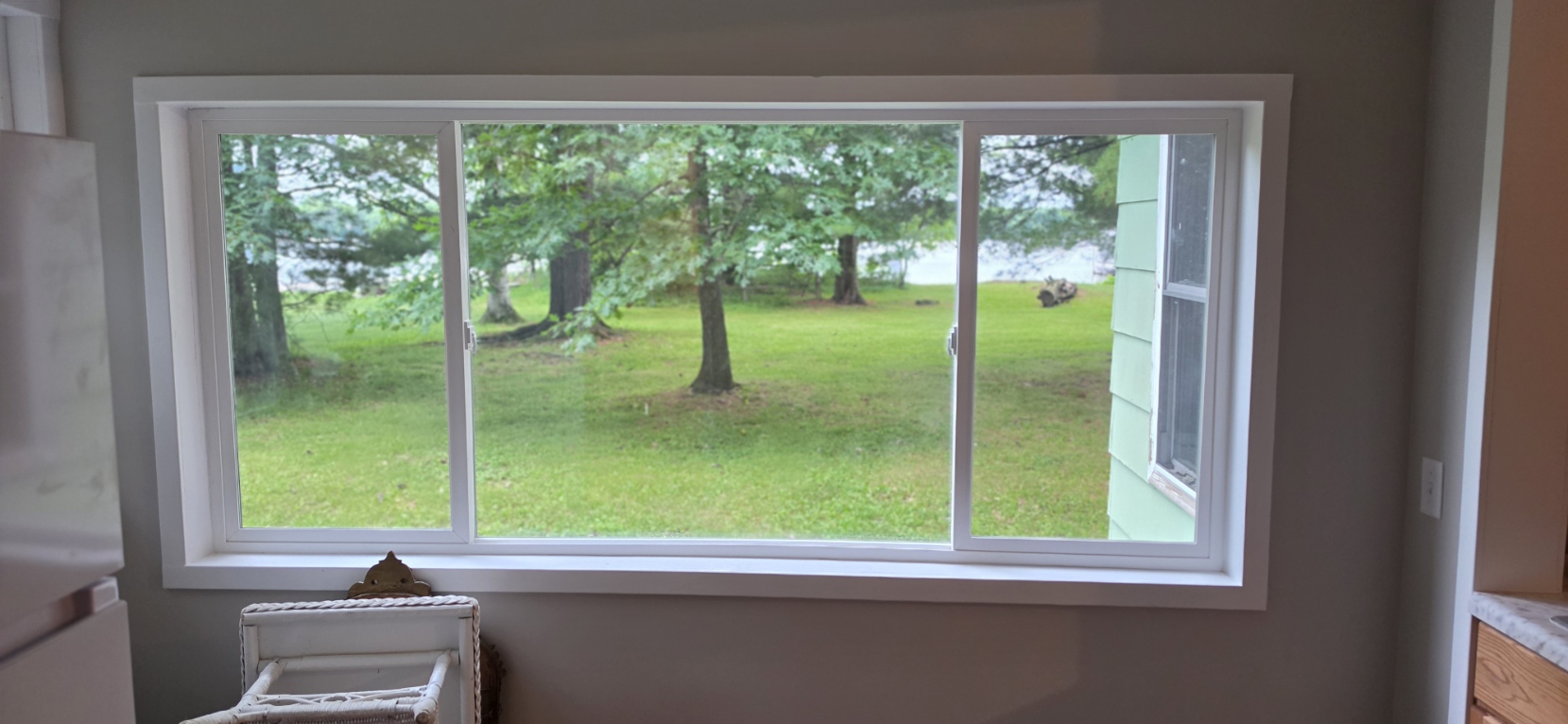 After — 3-panel picture window framing the Bone Lake yard