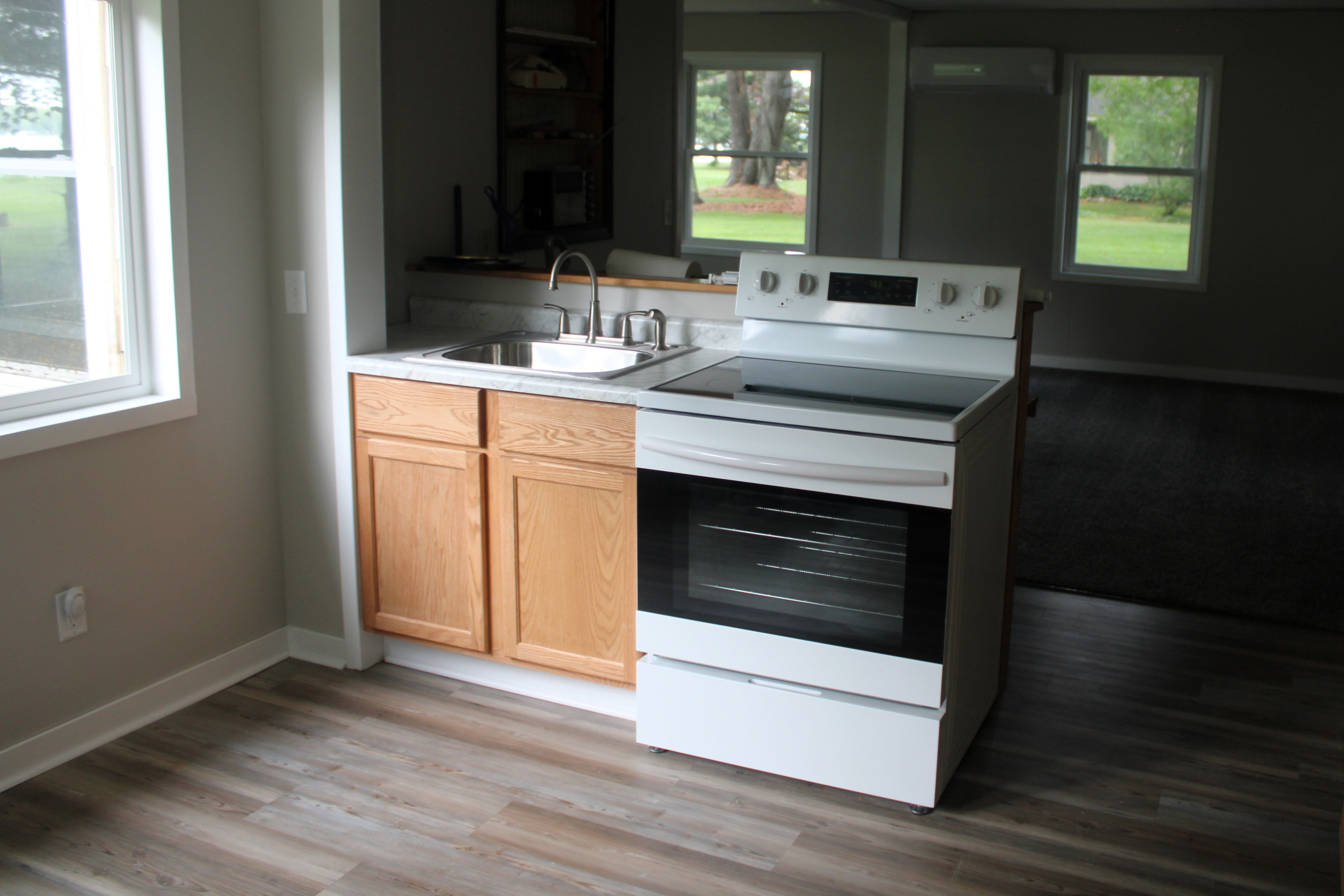 After — kitchen cabinetry and marble-look countertops