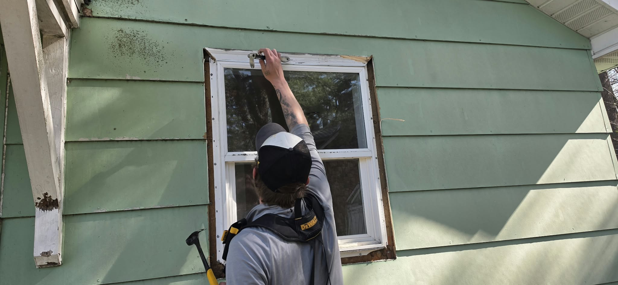 During construction — crew member working on window installation, Bone Lake cabin